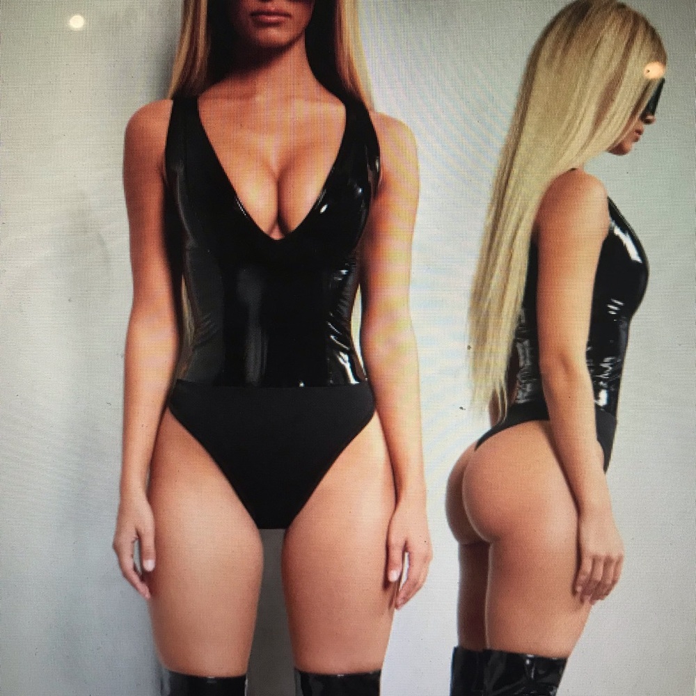Woman’s deep plunge vinyl bodysuit